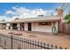 Single-story house with neutral gravel yard and brick fire pit offers a relaxed outdoor living space at 4144 N 29Th Ave, Phoenix, AZ 85017