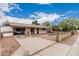 Single-story home with long driveway leading to the house; front yard features a small bricked area at 4144 N 29Th Ave, Phoenix, AZ 85017
