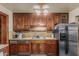 Kitchen featuring wood cabinetry, stainless steel refrigerator, and laminate countertop, offering a functional cooking space at 4144 N 29Th Ave, Phoenix, AZ 85017