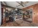 View of the cluttered living room with paneled walls and a glimpse into the adjacent kitchen area at 4144 N 29Th Ave, Phoenix, AZ 85017