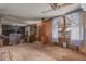 Spacious living room featuring wood paneling, vintage carpet, and large windows for ample natural light at 4144 N 29Th Ave, Phoenix, AZ 85017