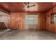Living room with wood walls, ceiling fan, and access to a bar area at 4144 N 29Th Ave, Phoenix, AZ 85017