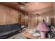 Office space showcasing wood paneled walls, desk, futon, and ample storage, ideal for a dedicated workspace at 4144 N 29Th Ave, Phoenix, AZ 85017
