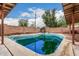 Backyard pool with surrounding brick wall and tree-lined background at 4144 N 29Th Ave, Phoenix, AZ 85017