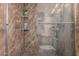 Walk in shower stall with brown marble tiling and glass doors at 4144 N 29Th Ave, Phoenix, AZ 85017