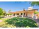 Lush backyard with covered patio, brick pavers, cozy firepit, and manicured landscaping at 4349 W Cielo Grande --, Glendale, AZ 85310