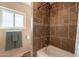 Tiled bathroom with bathtub and shower and a window for natural lighting at 4349 W Cielo Grande --, Glendale, AZ 85310