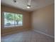 Bright bedroom featuring a ceiling fan and a large window showcasing a lush green tree at 4349 W Cielo Grande --, Glendale, AZ 85310