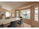 Dining area with a large window, fireplace, tile floor and dining room set at 4349 W Cielo Grande --, Glendale, AZ 85310