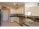 Functional kitchen with granite counters, tile floors, stainless steel appliances and breakfast bar at 4349 W Cielo Grande --, Glendale, AZ 85310