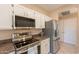 Charming kitchen showcases stainless steel appliances and white cabinets with ample storage space at 4349 W Cielo Grande --, Glendale, AZ 85310
