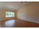Spacious living room features wood floors, large window, and neutral wall color at 4349 W Cielo Grande --, Glendale, AZ 85310