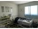 Bedroom with a white bed frame, side table, and decorations on a shelf at 4410 N 50Th Dr, Phoenix, AZ 85031