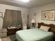 Cozy bedroom with wood furniture, soft lighting, and carpeted floors at 4410 N 50Th Dr, Phoenix, AZ 85031