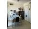Simple dining area with a covered table, cabinet, and tile flooring at 4410 N 50Th Dr, Phoenix, AZ 85031