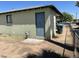 Back exterior of the home with a door, window, and the yard space at 4410 N 50Th Dr, Phoenix, AZ 85031