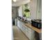 Galley kitchen with retro appliances, cabinets, and a washing machine at 4410 N 50Th Dr, Phoenix, AZ 85031