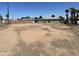 A view of the large backyard with the house exterior and palm trees at 4410 N 50Th Dr, Phoenix, AZ 85031