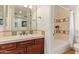 Bathroom featuring single sink vanity with tile countertop and enclosed shower tub combination with tiled surround at 4419 N 24Th Way, Phoenix, AZ 85016
