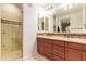 Bathroom features a double sink vanity, large mirror, and a glass enclosed walk-in shower at 4419 N 24Th Way, Phoenix, AZ 85016