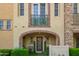 Charming home entrance featuring an arched doorway, decorative door, manicured greenery, and a quaint seating area at 4419 N 24Th Way, Phoenix, AZ 85016