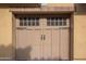 Tan garage door with decorative windows and handles at 4419 N 24Th Way, Phoenix, AZ 85016