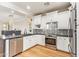 Well-lit kitchen with stainless steel appliances, white cabinetry and a decorative backsplash at 4419 N 24Th Way, Phoenix, AZ 85016