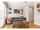 Cozy living room with a blue sofa, wood floors, stylish decor, and natural light at 4419 N 24Th Way, Phoenix, AZ 85016