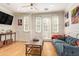 Cozy living room with a comfortable couch, hardwood floors, a decorative side table, and ample natural light at 4419 N 24Th Way, Phoenix, AZ 85016