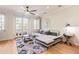Bright living room with a modern sofa, stylish decor, ceiling fan, and French doors to an outdoor balcony at 4419 N 24Th Way, Phoenix, AZ 85016