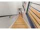 Top-down view of a modern wooden staircase with black railings, leading to bright spaces and stylish interiors at 4419 N 24Th Way, Phoenix, AZ 85016