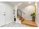 Modern staircase with wood treads, black metal railings, decorative tile landing, and a stylish pet space below at 4419 N 24Th Way, Phoenix, AZ 85016