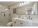 Modern bathroom with double vanity, quartz countertop, glass enclosed shower, and neutral tones at 4509 E La Puente Ave, Phoenix, AZ 85044