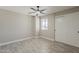 A bright bedroom features light walls, modern ceiling fan and plank floors at 4509 E La Puente Ave, Phoenix, AZ 85044