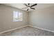 A bright bedroom features light walls, a window for natural light and plank floors at 4509 E La Puente Ave, Phoenix, AZ 85044