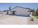 View of the two-car garage and low-maintenance landscaping of this single-story home at 4509 E La Puente Ave, Phoenix, AZ 85044