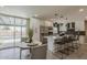 Modern kitchen with stainless steel appliances, island seating, and easy access to the pool at 4509 E La Puente Ave, Phoenix, AZ 85044