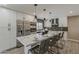 Modern kitchen featuring stainless steel appliances, quartz countertops, and a large island with seating at 4509 E La Puente Ave, Phoenix, AZ 85044