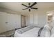 Bright main bedroom featuring neutral colors, a ceiling fan, a walk-in closet, and modern accents at 4509 E La Puente Ave, Phoenix, AZ 85044