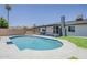 An inviting pool is nestled in a beautifully landscaped backyard perfect for relaxing and entertaining at 4509 E La Puente Ave, Phoenix, AZ 85044