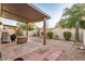 Backyard features a covered patio, desert landscaping, and a cozy seating area at 5445 E Mckellips Rd # 23, Mesa, AZ 85215