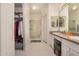 Bathroom with dual sinks, walk-in shower, and closet space at 5445 E Mckellips Rd # 23, Mesa, AZ 85215