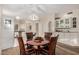 Well-lit dining area with a wooden table, chairs, and seamless flow into the kitchen and living areas at 5445 E Mckellips Rd # 23, Mesa, AZ 85215
