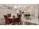 Dining area with wooden table, chairs and modern lighting. The kitchen is in the background at 5445 E Mckellips Rd # 23, Mesa, AZ 85215