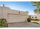 Neutral garage door with bronco art matches the home's southwestern aesthetic in front of manicured landscaping at 5445 E Mckellips Rd # 23, Mesa, AZ 85215