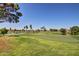 Scenic golf course view with lush green fairways and a tranquil lake at 5445 E Mckellips Rd # 23, Mesa, AZ 85215
