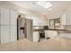 This kitchen is equipped with stainless steel appliances, white cabinets, a skylight, and granite countertops at 5445 E Mckellips Rd # 23, Mesa, AZ 85215
