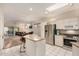 Open kitchen with stainless steel appliances, white cabinets, granite countertops, and an island facing the living room at 5445 E Mckellips Rd # 23, Mesa, AZ 85215