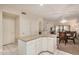 Kitchen island with white cabinets and granite countertops, adjacent to the dining room and living room at 5445 E Mckellips Rd # 23, Mesa, AZ 85215