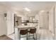 Bright kitchen features white cabinets, stainless steel appliances, granite countertops, and an island with seating at 5445 E Mckellips Rd # 23, Mesa, AZ 85215